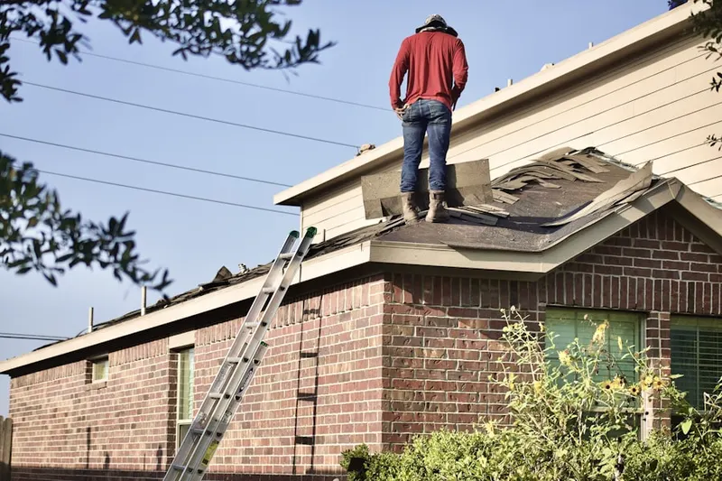 Professional roofer working on a residential roof in Concordia